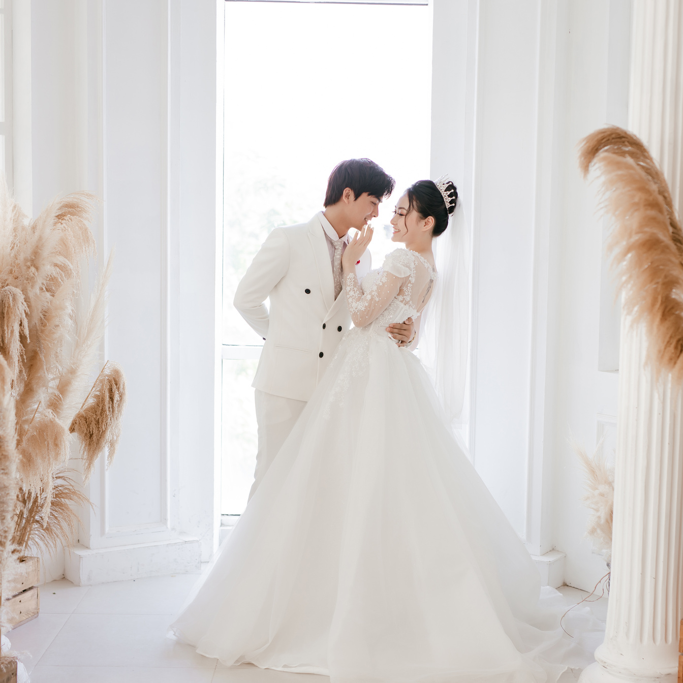 Bride and Groom Kissing on White Floor Tiles